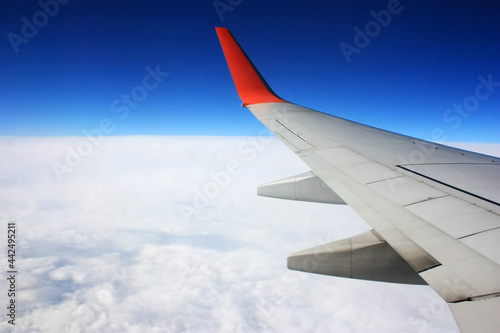 Airplane wing in the blue sky