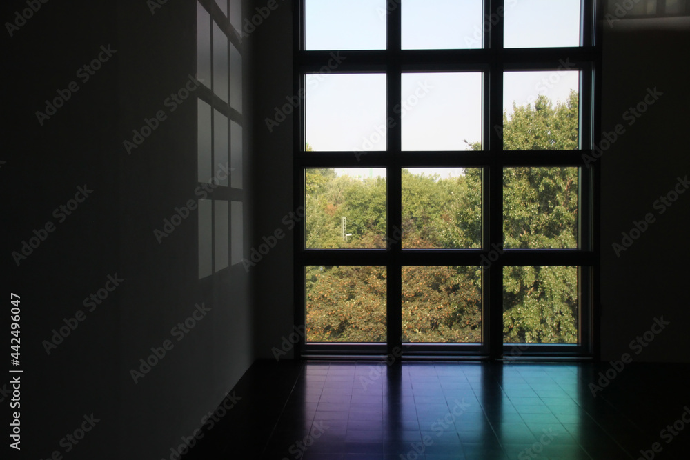 Minimalistic window in building. Modern architecture with nature. Trees in front of window. Minimalistic window in building. Modern architecture with nature. Trees in front of window.