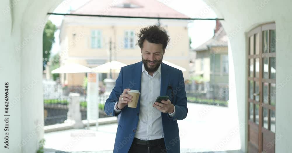cool bearded man with long moustache checking social media, drinking coffee, walking and laughing on city background outdoor cool bearded man with long moustache checking social media, drinking coffee, walking and laughing on city background outdoor