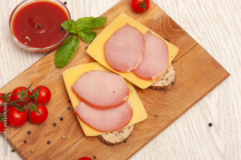 Smoked meat with tomatoes and herbs on a wooden board Smoked meat with tomatoes and herbs on a wooden board