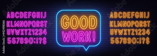 Good Work neon quote on a brick wall.