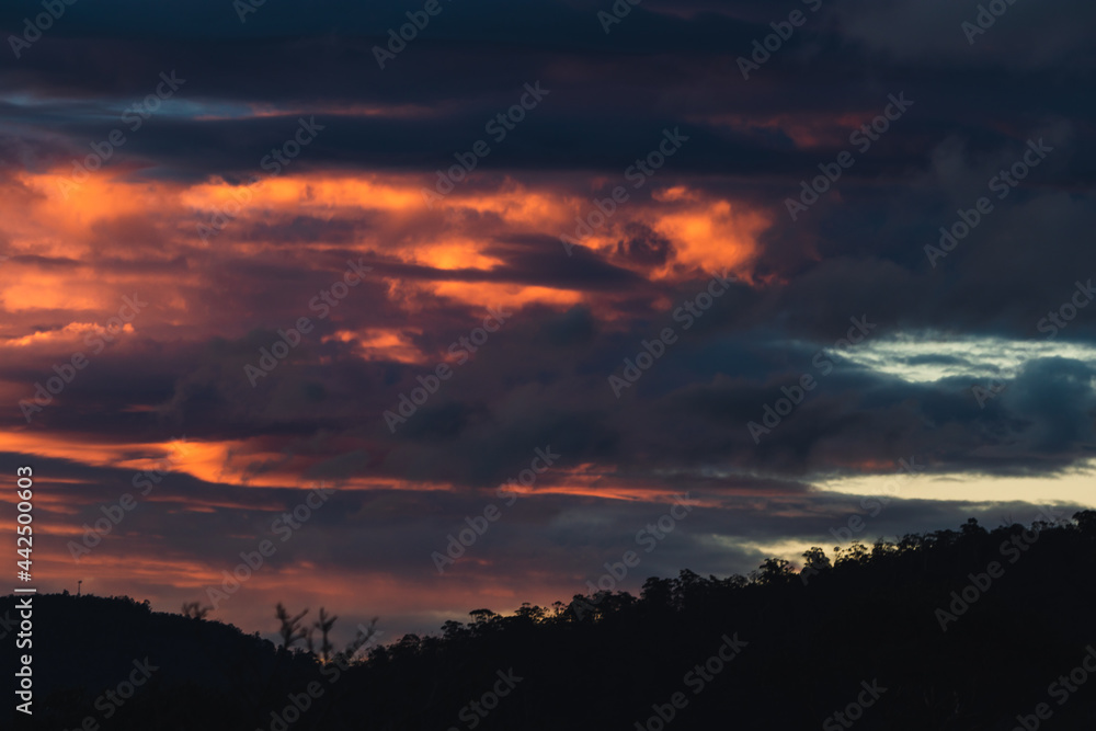 sunset sky with pink and orange clouds over the mountains