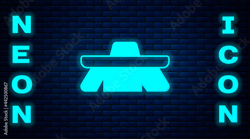 Glowing neon Brush for cleaning icon isolated on brick wall background. Cleaning service concept. Vector