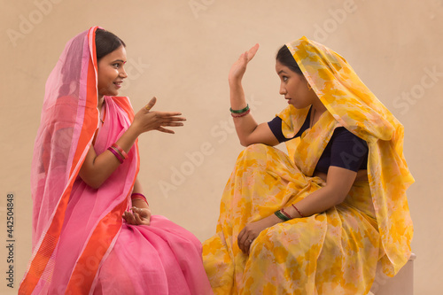 Two rural women talking to each other. photo