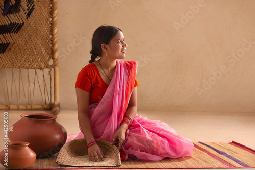 A rural woman handpicking grains in a sieve. photo