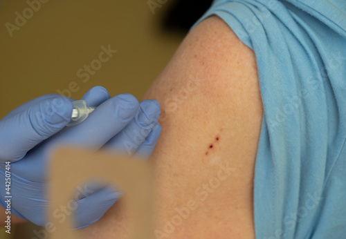 A nurse injects the Pfizer / BioNTech Comirnaty COVID-19 vaccine into a patient's shoulder.