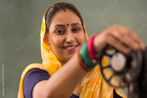 A woman working with a sewing machine. photo