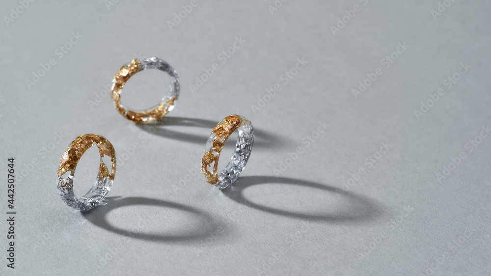 Elegant clear resin rings with half golden filling Elegant clear resin rings with half golden filling