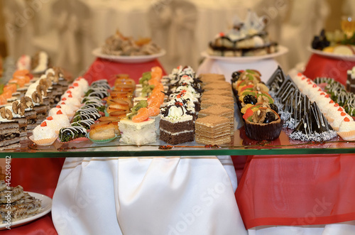 Wallpaper Mural Catering a lot of sweet snacks from small cakes with cream and chocolate cream and fruit on the glass in the banquet hall Torontodigital.ca