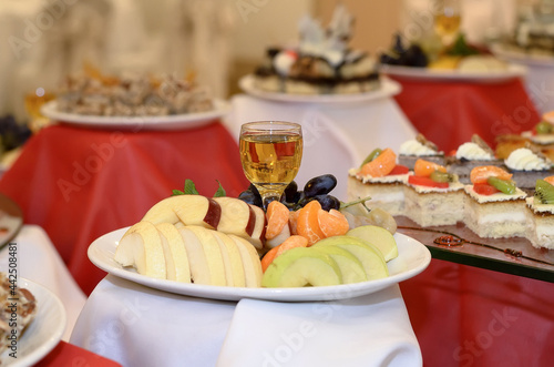 Wallpaper Mural Catering plate with sliced fruit apples, pears, tangerine slices, grapes and a glass of apple juice Torontodigital.ca