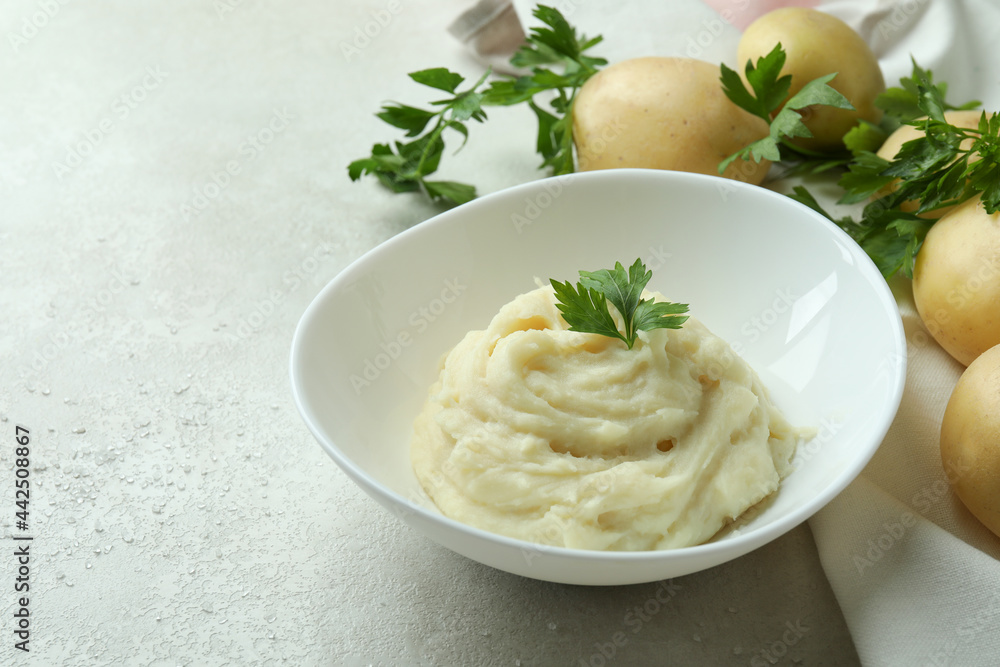 Concept of tasty eating with mashed potatoes on white textured table Concept of tasty eating with mashed potatoes on white textured table