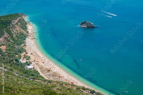 Portinho da Arrábida beach in aerial view with extensive sand and rock in the sea, Setúbal PORTUGAL photo