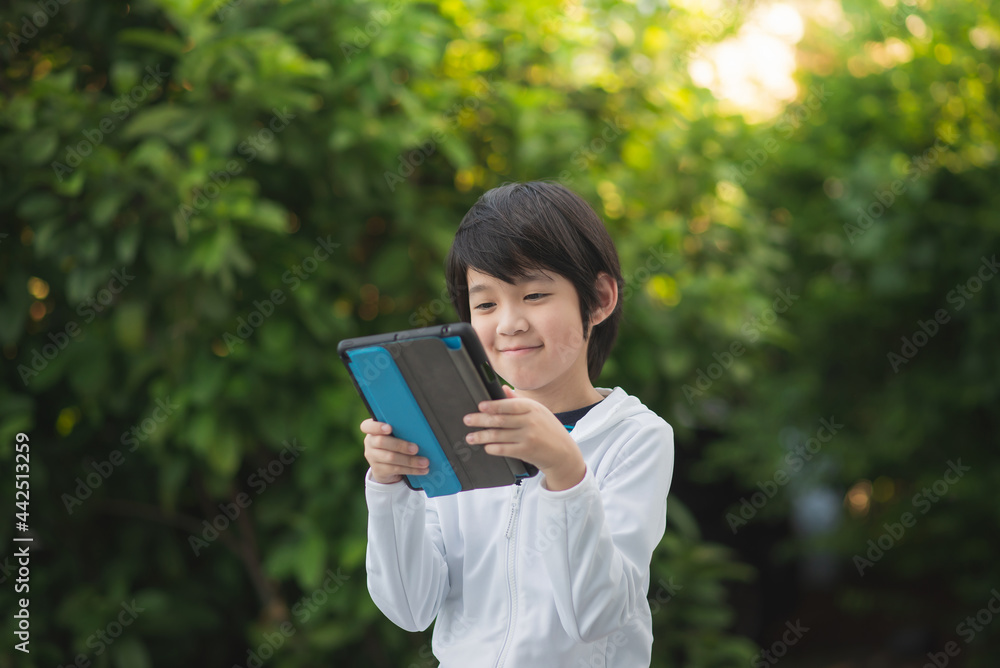 Asian child learning class study online with video call from tablet Asian child learning class study online with video call from tablet
