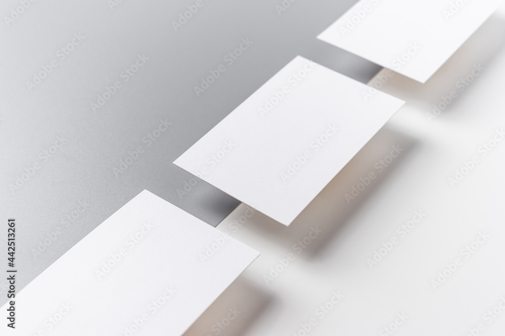 Top view of business card isolated on white & grey Top view of business card isolated on white & grey