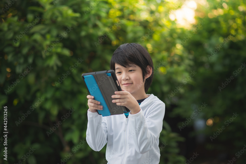 Asian child learning class study online with video call from tablet Asian child learning class study online with video call from tablet