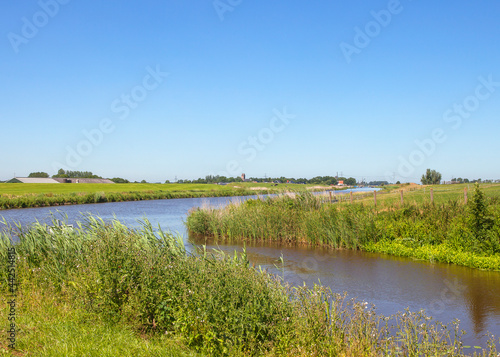 Dutch landscape with canal and village © Patricia