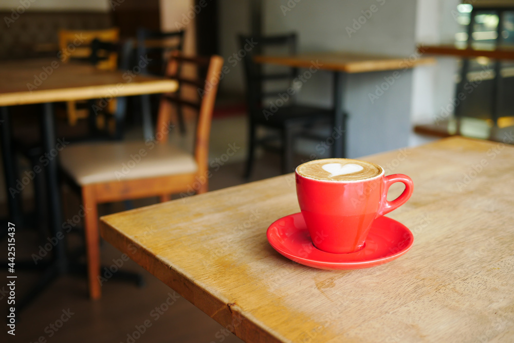 a cup of late coffee with flower shape design on top at cafe a cup of late coffee with flower shape design on top at cafe