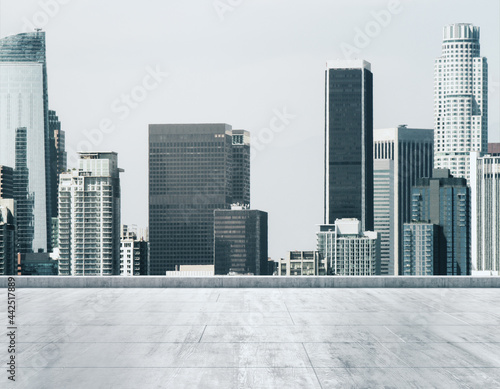 Empty concrete dirty rooftop on the background of a beautiful Los Angeles city skyline at morning, mockup