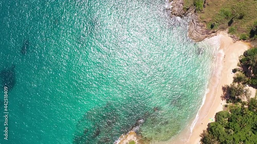 aerial top view above small island in front of Yanui beach..white bubble waves in turquoise sea hit on the rock. .creative nature and travel concept. photo