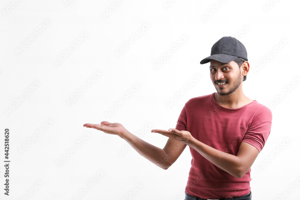 Young indian delivery boy showing expression over white background. Young indian delivery boy showing expression over white background.