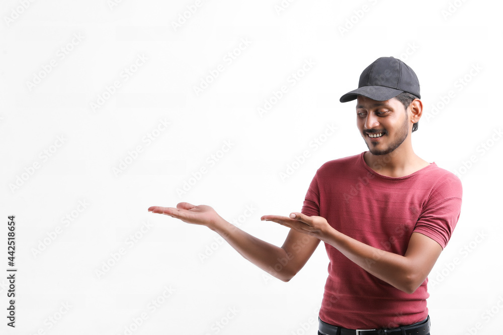 Young indian delivery boy showing expression over white background. Young indian delivery boy showing expression over white background.