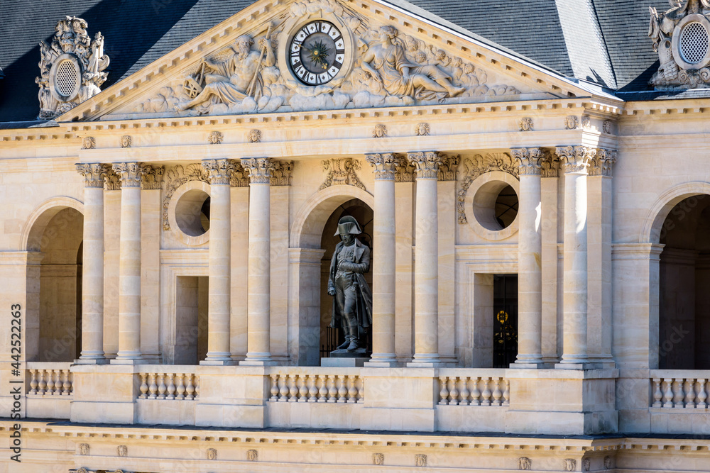 Side view of the southern facade of the court of honor of the Hotel des Invalides in Paris, France, with the statue of Napoleon Bonaparte on the balcony.