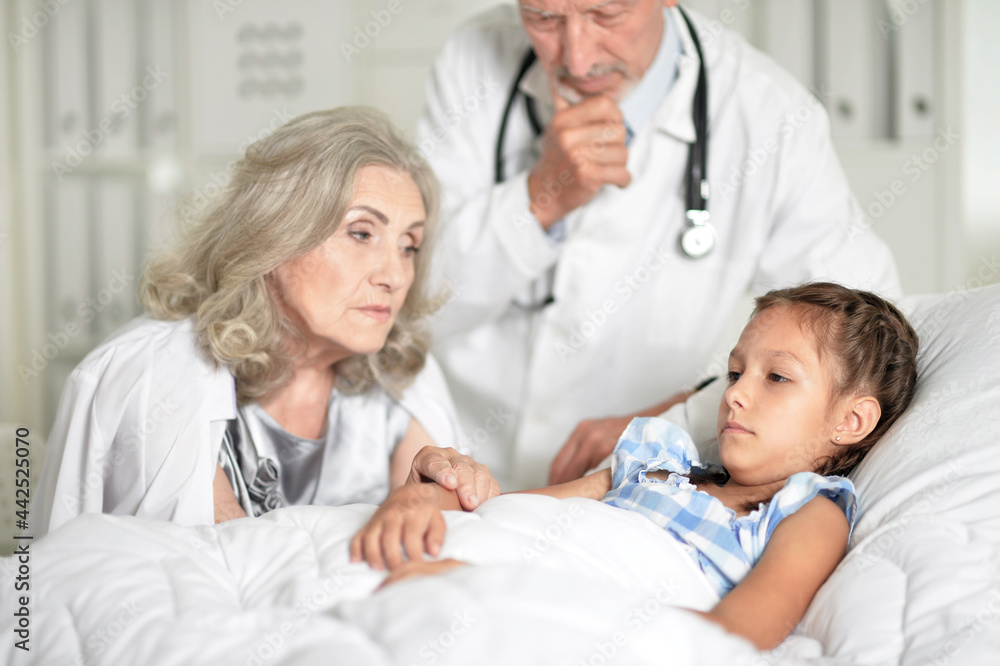 sad senior woman with granddaughter in hospital ward sad senior woman with granddaughter in hospital ward