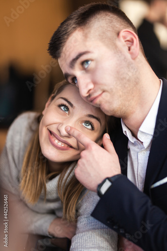 Lovely couple fooling around at a cafe. Funny face expressions. © Nikola Spasenoski