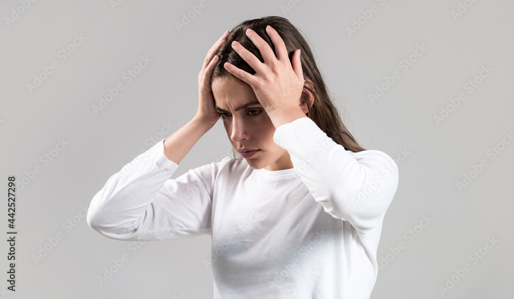Brunette woman touching her temples feeling stress, on gray background. Woman suffering from headache desperate, stressed because pain and migraine. Woman with hard headache holding hands on head Brunette woman touching her temples feeling stress, on gray background. Woman suffering from headache desperate, stressed because pain and migraine. Woman with hard headache holding hands on head