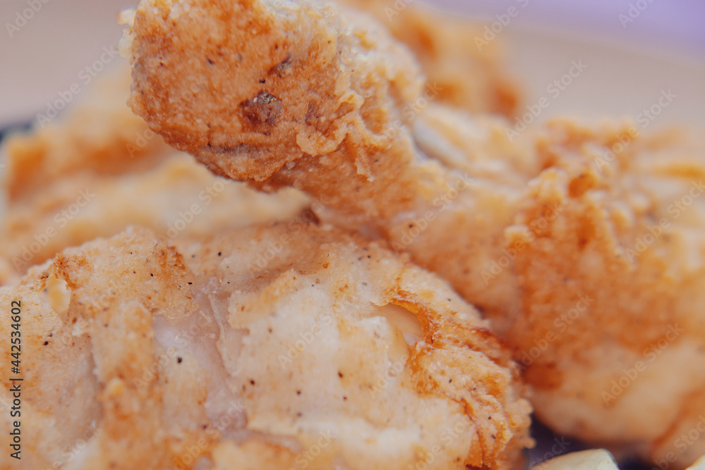 Close-up of food is easily blurred in soft focus. A plate of fries and fried chicken. Close-up of food is easily blurred in soft focus. A plate of fries and fried chicken.