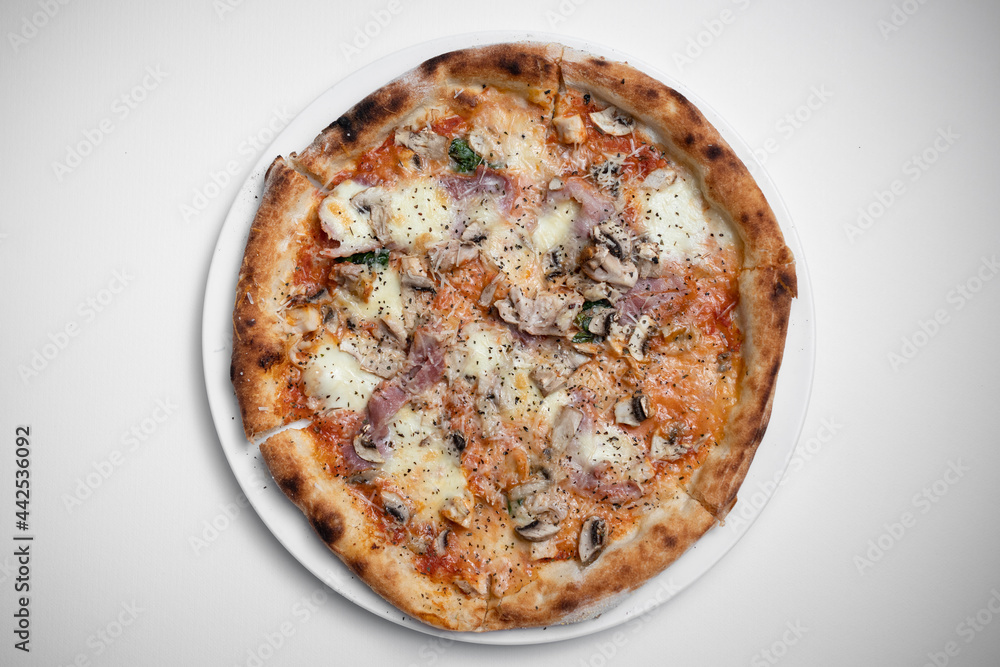 top view of italian pizza with ham, mushrooms and cheese on white background top view of italian pizza with ham, mushrooms and cheese on white background