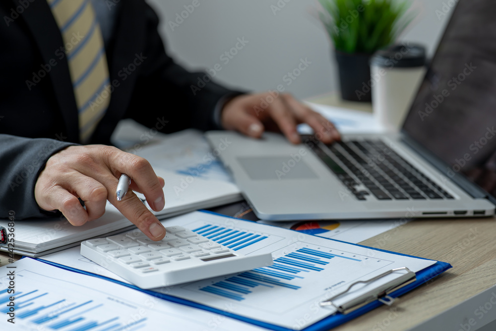 Financial Business man analyze the graph of the company's performance to create profits and growth, Market research reports and income statistics, Financial and Accounting concept. Financial Business man analyze the graph of the company's performance to create profits and growth, Market research reports and income statistics, Financial and Accounting concept.