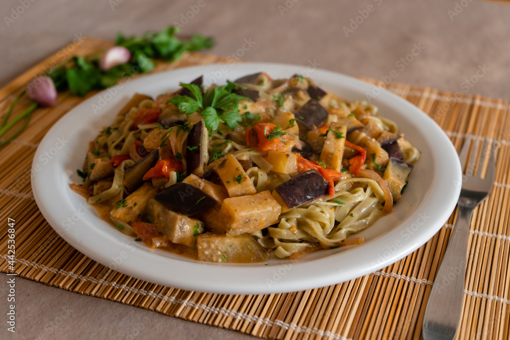 Close-up of spinach noodles with sautéed vegetables. Healthy food concept. Close-up of spinach noodles with sautéed vegetables. Healthy food concept.