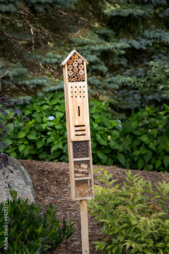 Insect box in a garden attracts beneficial insects.