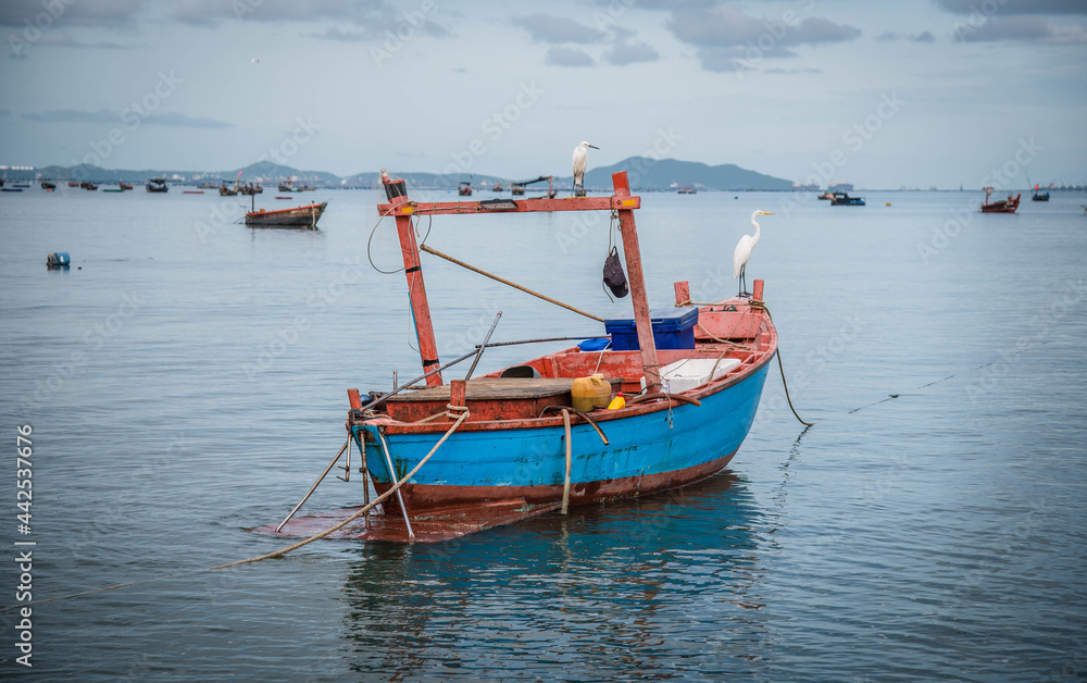Local fishermen parked on the beach at Ban Bang Phra fishing boat pier, Thailand, June 29, 2021.