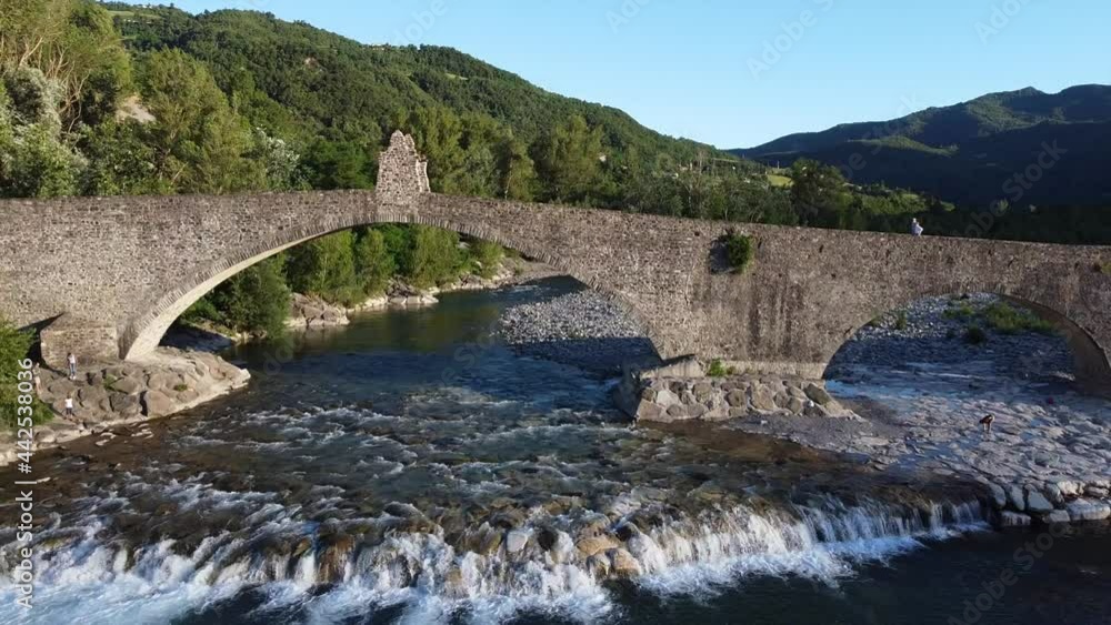Europe, Italy , Bobbio , Piacenza ,Val Trebbia- Drone aerial view of roman historic stones bridge Ponte Gobbo o Ponte Vecchio and Bobbio village Europe, Italy , Bobbio , Piacenza ,Val Trebbia- Drone aerial view of roman historic stones bridge Ponte Gobbo o Ponte Vecchio and Bobbio village
