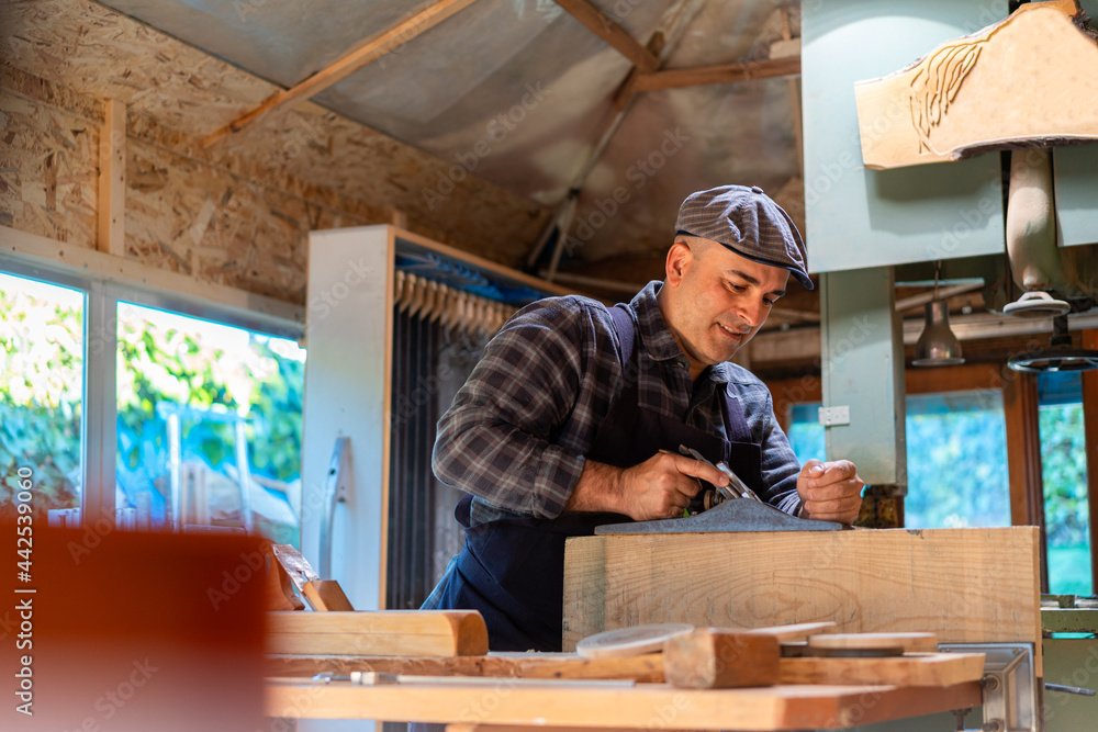 Carpenter working wit jointer plane in workshop Carpenter working wit jointer plane in workshop