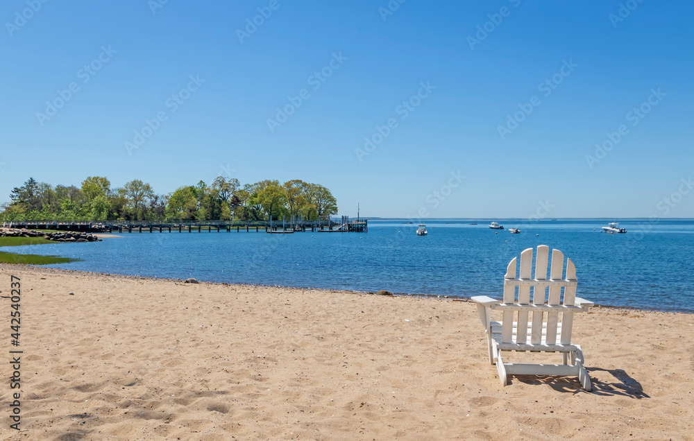 white adirondack chair on the beach white adirondack chair on the beach