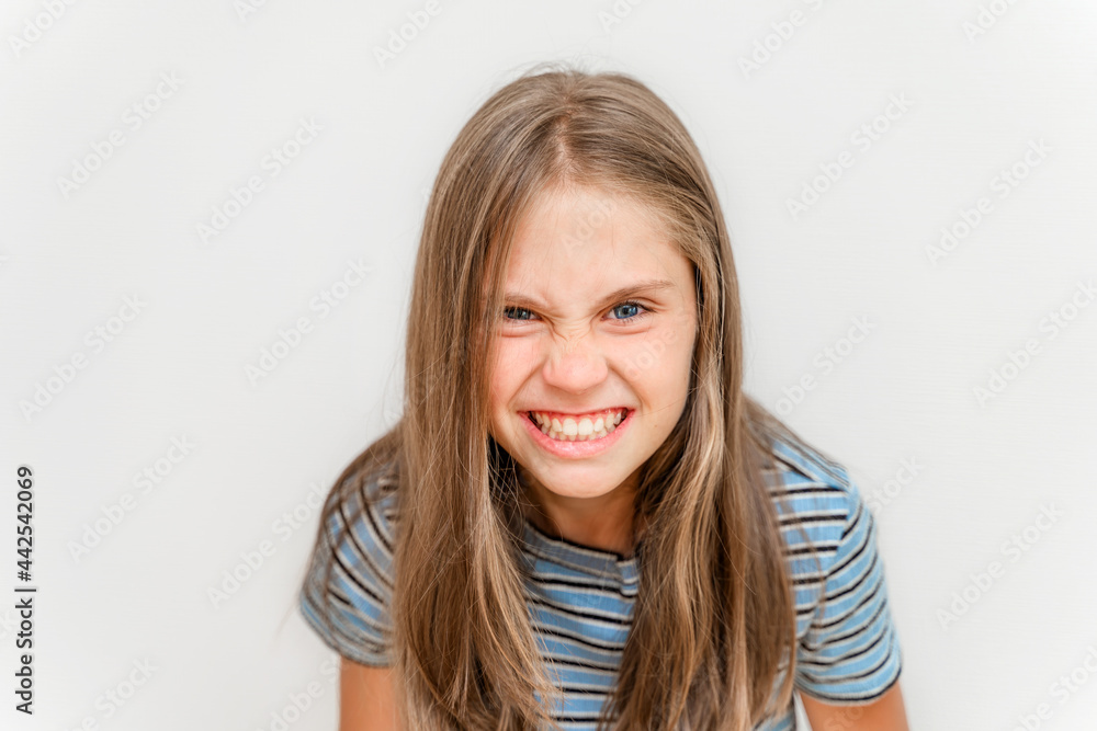 A portrait of little girl grins and makes faces A portrait of little girl grins and makes faces