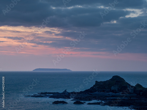 Sunset view of Lundy island from Hartland beach. Devon, UK. photo