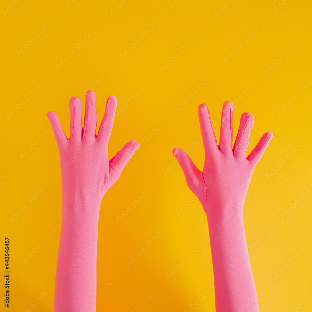 hands with pink glove and number ten on yellow sunny summer background. modern summer abstract art hands with pink glove and number ten on yellow sunny summer background. modern summer abstract art