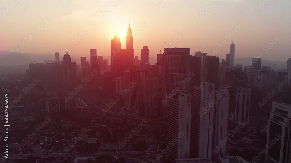 Dramatic and orange aerial view Kuala Lumpur city in the morning with the silhouette of Kuala Lumpur city skyline