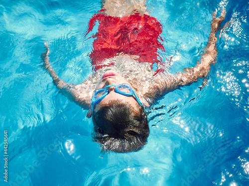 young boy swimming on a swimming pool. close up look