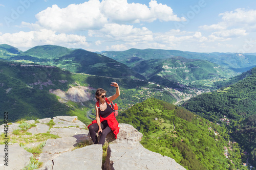 Tourist Woman with Backpack on the Top of Summer Mountain with Stunning View. Summer Mountain in Bulgaria ,Bov Village ,Balkan Mountain ,Iskar Gorge
