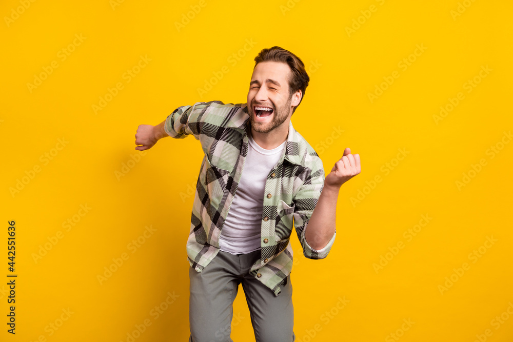 Photo of cheerful young positive happy man dance good mood funky funny isolated on yellow color background Photo of cheerful young positive happy man dance good mood funky funny isolated on yellow color background