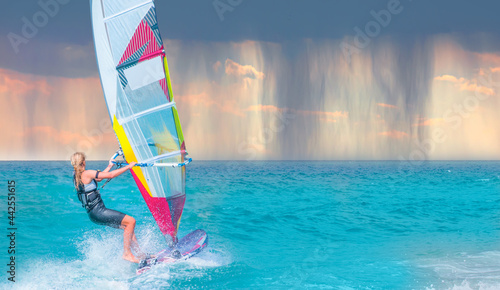 A female windsurfing on a rainy day