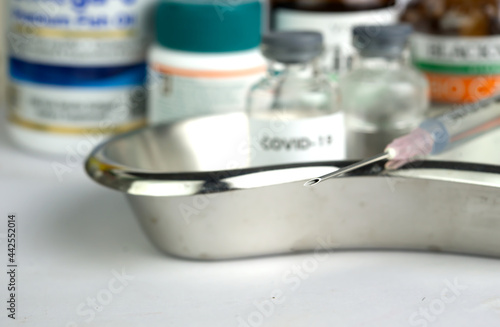 Syringe close up with medicine background.