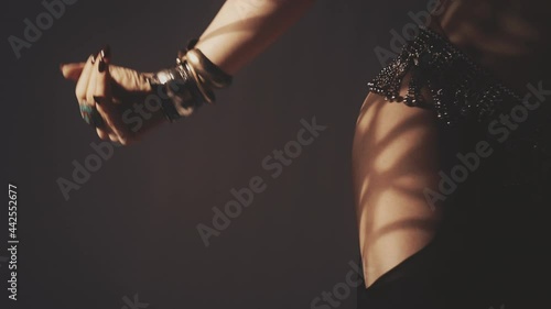 Sensual woman dancing in light and shadow