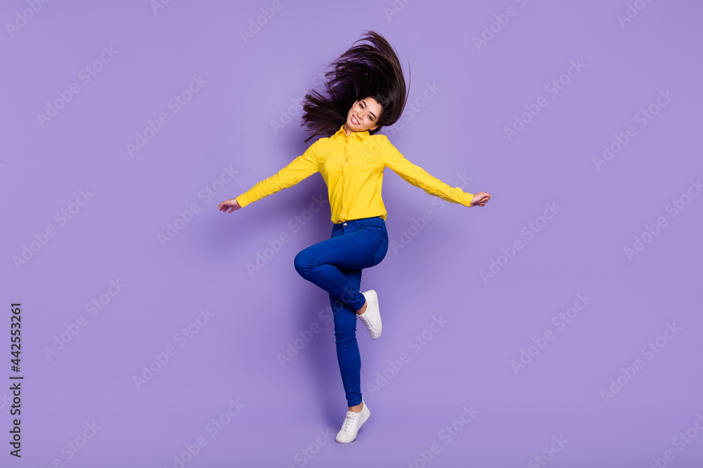 Full length photo of lovely sweet young lady jump up smile fly hair trip weekend isolated on violet color background