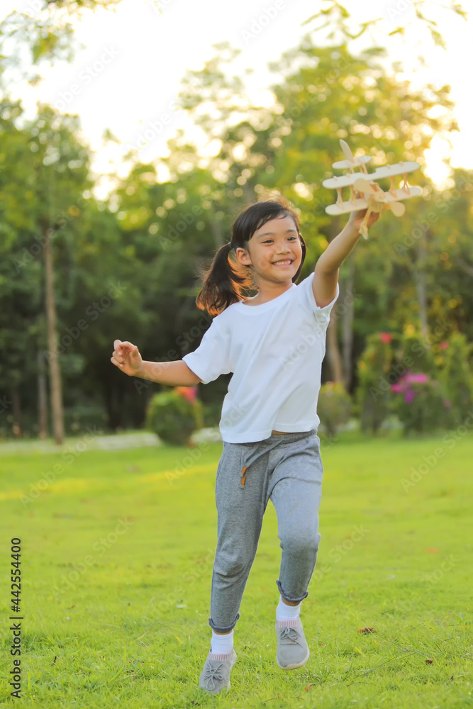 Cute little girl asia playing toy airplane on nature in the park. Little dreams of flying limitless imagination .Which increases the development and enhances learning skills. Cute little girl asia playing toy airplane on nature in the park. Little dreams of flying limitless imagination .Which increases the development and enhances learning skills.